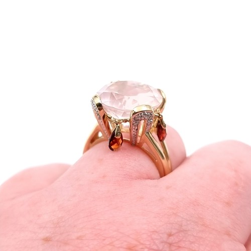 9 - Star lot : A very large pink topaz  ring set in nine carat gold with claw mount. Size - O 1/2. Weigh... 