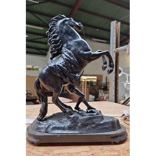 418 - Cast metal Marley Horse sculpture featuring a rearing horse and figure, detailed with expressive mov... 