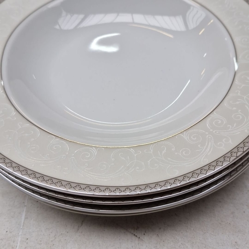 422 - Tipperary Crystal porcelain dinnerware set for four places, elegantly designed with intricate emboss... 