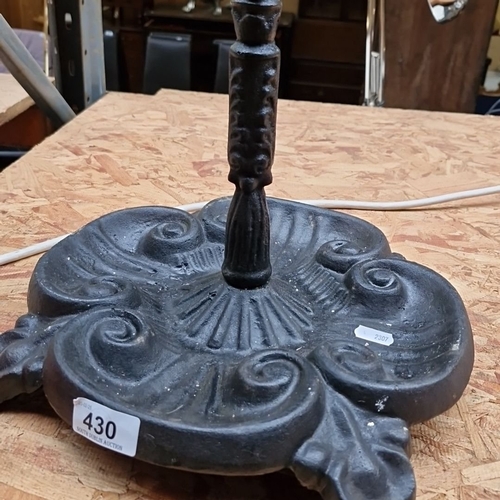 430 - A Victorian style cast iron umbrella / stick stand featuring ornate detailing and a circular holder,... 