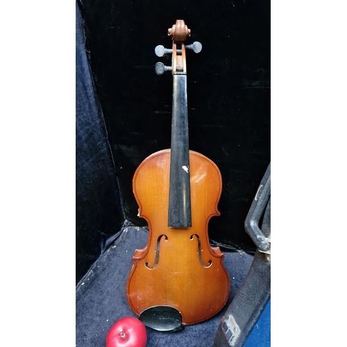 444 - 3/4 size violin with a warm-toned wooden body. Includes a fitted hard case with blue lining.