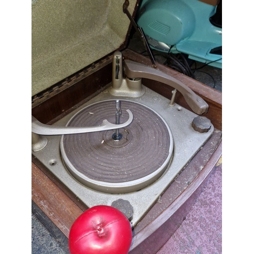 447 - Mid-20th century portable record player in a wooden case. Features a classic turntable design with i... 