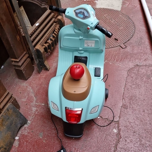 448 - Electric Vespa scooter for kids in pastel blue with brown seat and charger, not suitable for the M50