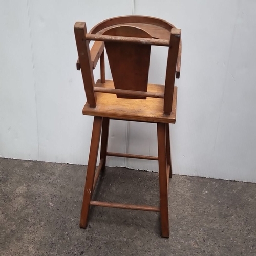 468 - A vintage wooden doll’s high chair, made from solid wood with a classic spindle-back design and remo... 