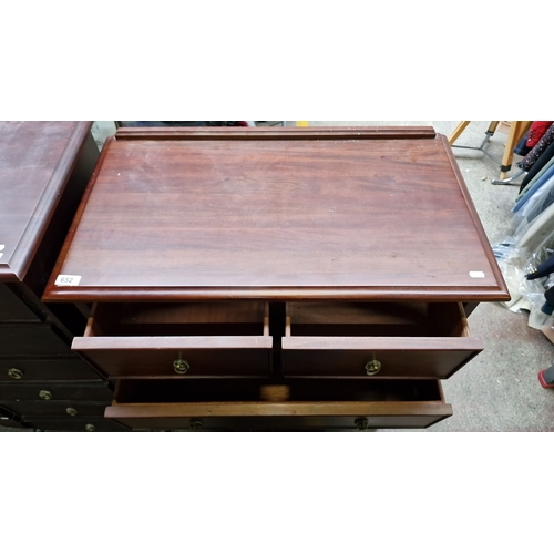 652 - Vintage mahogany chest of drawers featuring two short over four long drawers with brass ring handles... 