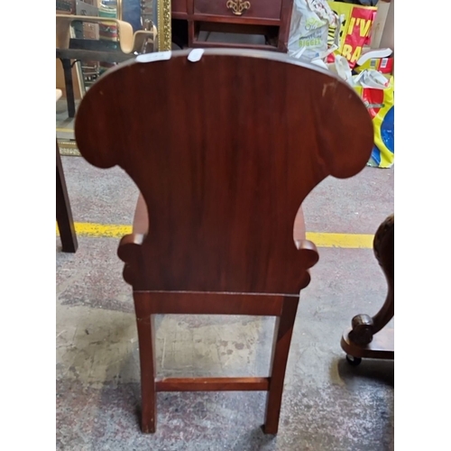 662 - Victorian-style carved mahogany chair with an ornate shield-shaped back and turned legs.