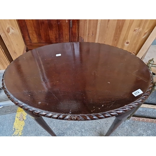 674 - Early 20th-century mahogany occasional table with an oval top, twisted rope-edge detail, and cabriol... 