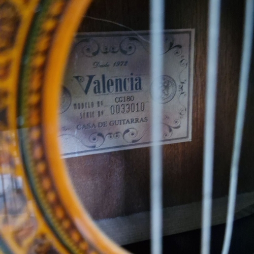 677 - Vintage classical acoustic guitar with rich wood tones and intricate rosette design. Slotted headsto... 