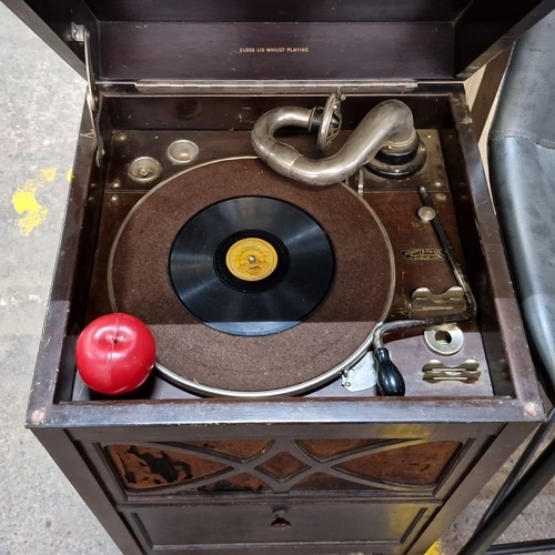 679 - Early 20th-century freestanding  gramophone housed in a wooden cabinet with Art Deco detailing. Feat... 