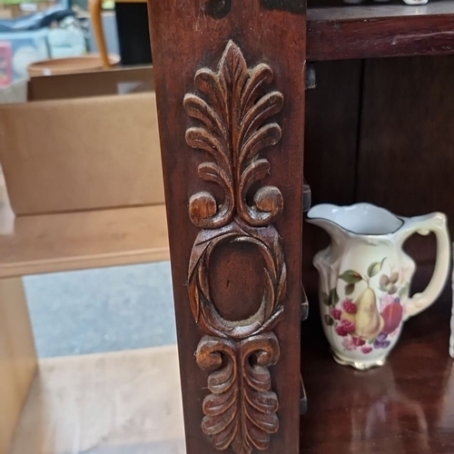 684 - Early 20th-century mahogany open bookcase with carved detailing, three shelves, and elegant cabriole... 