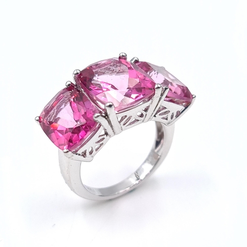 1407 - A three gemstone pink  ring set in sterling silver. Size - J 1/2. Weight - 5.88 grams. Boxed.
Previo... 