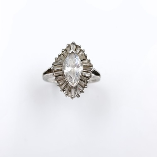 560 - A dazzling marquise cut cubic zirconia centre stone surrounded by tapered baguette cut cubic zirconi... 