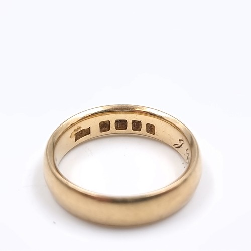 1 - Star Lot : An 18 carat gold wedding band ring with date inscription to band. Size - N. Weight - 6.35... 