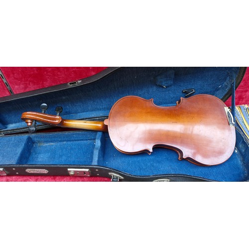 444 - 3/4 size violin with a warm-toned wooden body. Includes a fitted hard case with blue lining.