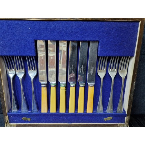 864 - A wooden canteen of silverplate cutlery including antique bone handled Harrison Fisher & Co, Sheffie... 