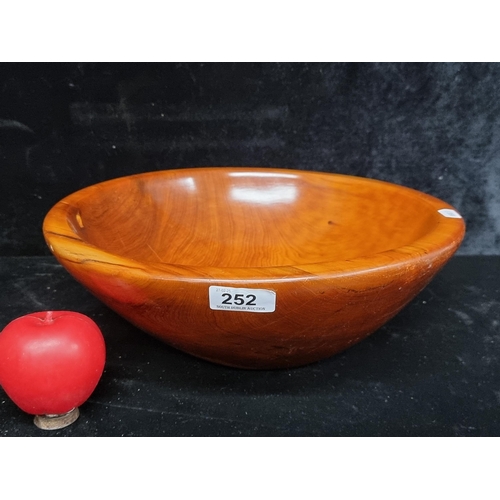 252 - A stunning hand turned yew wood bowl. Beautiful grain and iridescence to the wood.