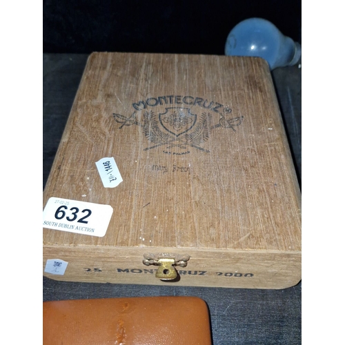 632 - Wooden cigar box filled with assorted coins and a leather coin purse.