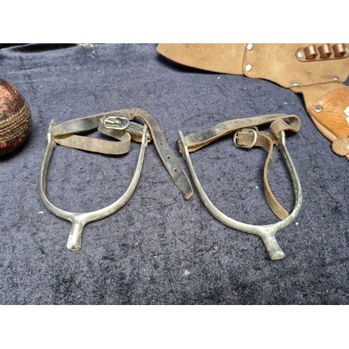 641 - Western equestrian lot includes a pair of vintage metal riding spurs with leather straps, a suede gu... 