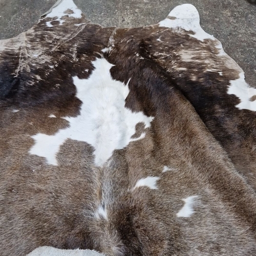 662 - Star Lot : Large natural large  cowhide rug with rich brown and white markings. Soft texture with hi... 