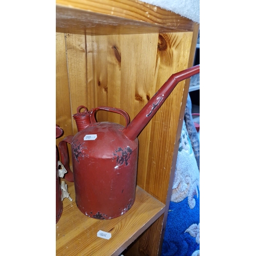 663 - Vintage stoneware storage jug with printed text, accompanied by two metal fuel oilers with red paint... 