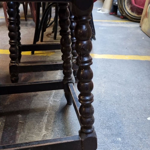 689 - Set of three vintage oak tripod vintage Irish pub tables with barley twist legs and a classic dark w... 