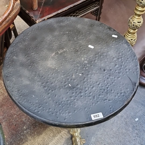 692 - Star Lot : A Pair of antique cast-iron pedestal tables with hammered black metal tops. Ornate gilt b... 