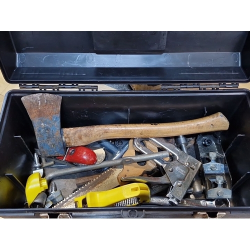 1148 - A black toolbox with dual latches, filled with assorted hand tools including an axe, saw, and clamps... 