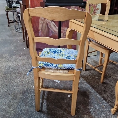 1149 - Star lot :A French Provincial-style dining set includes a parquet inlaid table with glass top and fo... 