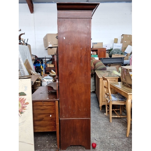 1157 - Star lot :An Early 20th-century mahogany wardrobe with mirrored door, inlaid detailing, and lower dr... 