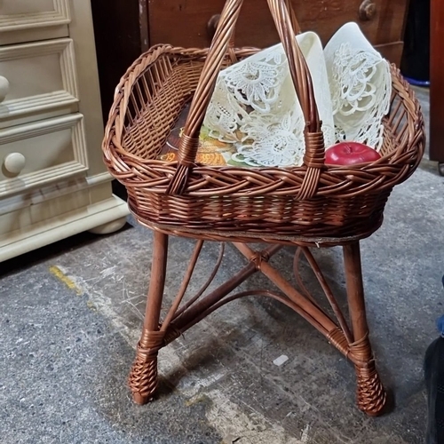 1163 - Vintage wicker basket on stand, featuring an elegantly woven design with a sturdy base and handle.