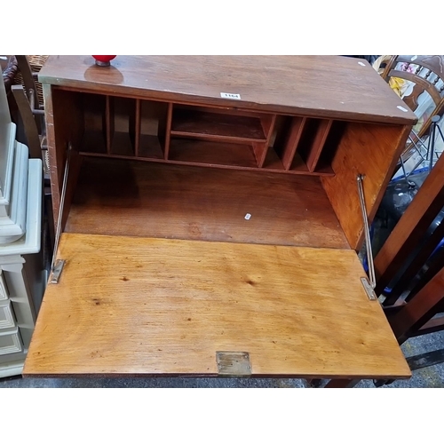 1164 - A Vintage wooden drop-front secretary desk with three drawers and interior compartments.