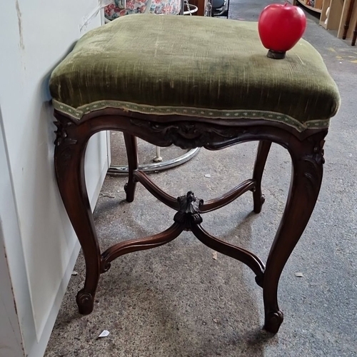 1184 - A 19th-century French Louis XV-style stool with ornate hand-carved mahogany frame and green velvet u... 