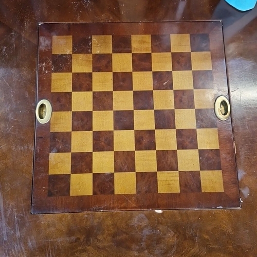 1185 - Star lot :A Vintage campaign-style gaming table featuring a built-in chessboard, brass accents, two ... 