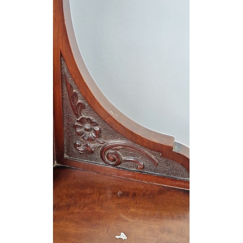 1188 - Star lot : A Victorian mahogany dressing table with an ornately carved mirror, turned legs, and mult... 