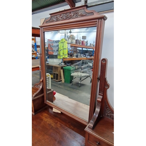 1188 - Star lot : A Victorian mahogany dressing table with an ornately carved mirror, turned legs, and mult... 