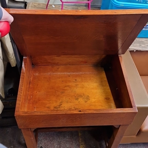 1193 - An mid 20th-century oak school desk with a lift-top compartment.