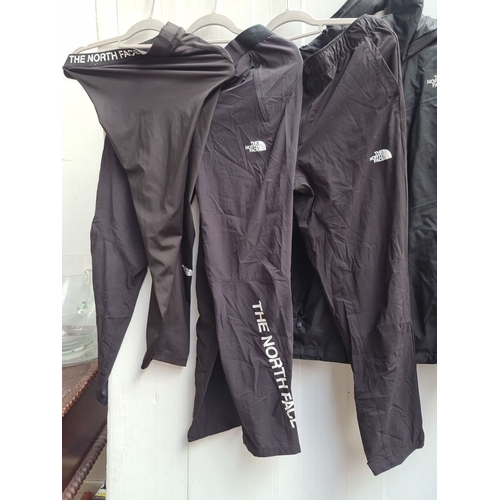 710 - North Face outdoor apparel lot, including waterproof jackets, leggings, and a pair of Futurelight hi... 