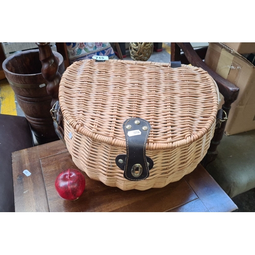 715 - Vintage wicker picnic hamper with leather straps, green fabric lining, and glassware.