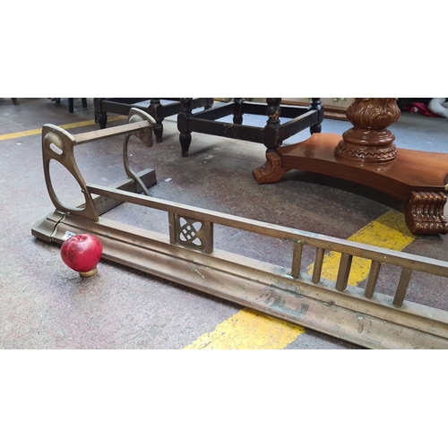 725 - A lovely Art Nouveau circa 1890 brass fireplace fender with pierced geometric detailing and curved s... 