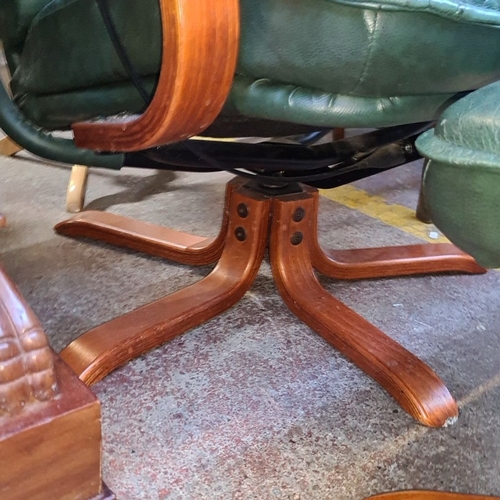 728 - Vintage green leather swivel lounge chair with matching ottoman, featuring a wooden frame, padded ar... 