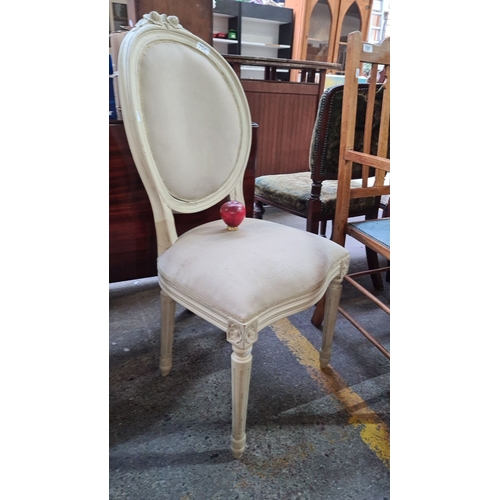 754 - A pair of Louis XVI-style carved wood fauteuil, painted cream with upholstered oval back and seat. F... 