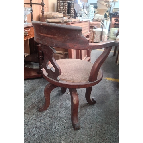 787 - 19th-century Victorian mahogany swivel desk chair with pierced backrest, scrolled armrests, and upho... 