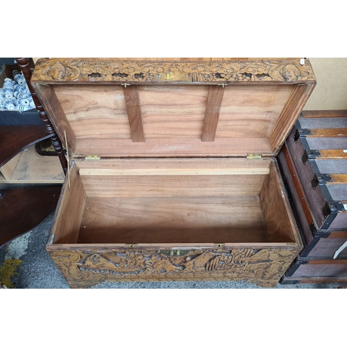 799 - Star Lot : A fabulous Hand-carved oriental camphor wood chest, richly decorated with intricate relie... 