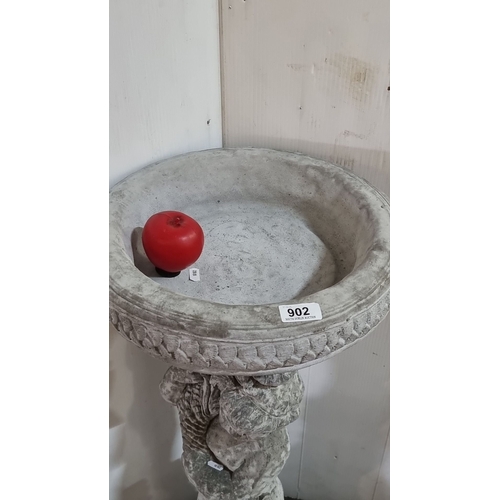 902 - Star lot :A Cast stone garden bird bath features a cherub pedestal base with intricate detailing.