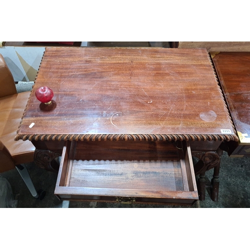 1312 - Antique mahogany writing table with gadrooned edges, single drawer, and cabriole legs with carved ac... 