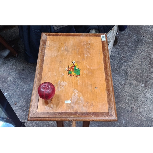 1313 - Vintage wooden occasional table with hand-painted folk figure. Rectangular top with inlaid border, s... 