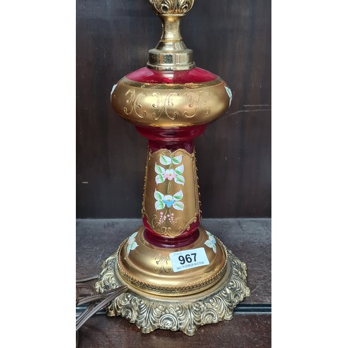 967 - Star Lot: A striking Venetian glass banquet lamp featuring cranberry glass, gilded accents, and hand... 