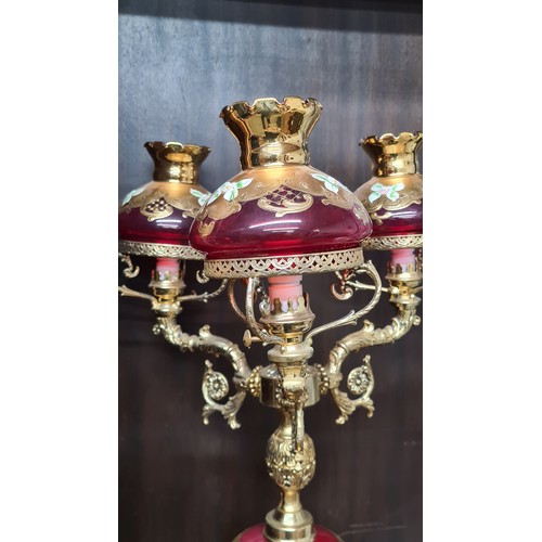 967 - Star Lot: A striking Venetian glass banquet lamp featuring cranberry glass, gilded accents, and hand... 