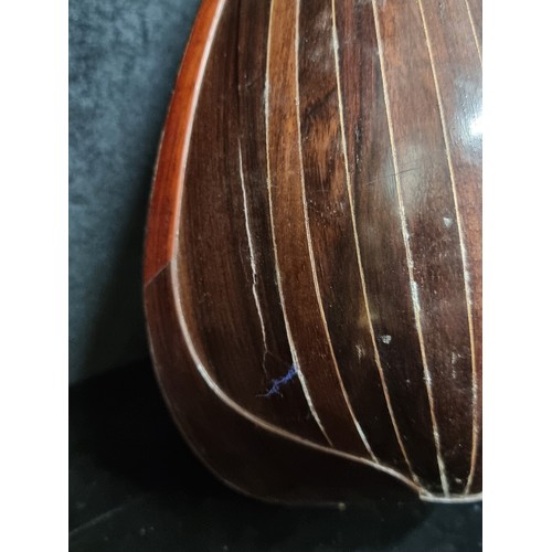 107 - A beautiful Mandolin in original hard carry case. Instrument has mother of pearl detailing to fret b... 