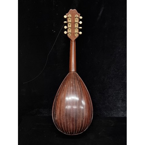 107 - A beautiful Mandolin in original hard carry case. Instrument has mother of pearl detailing to fret b... 